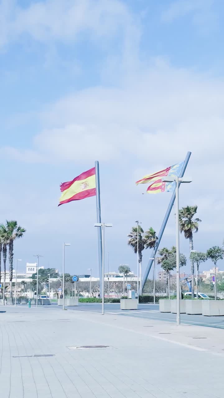 Spanish and Catalan Flags on a Sunny Day in a City