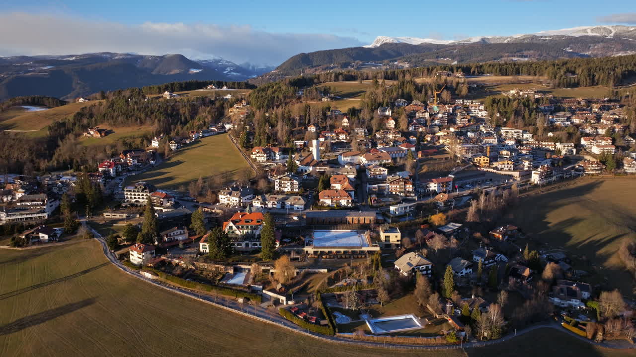 Aerial drone view of the Soprabolzano village on the Renon plateau in the Dolomites, Italy