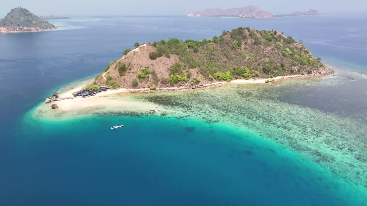 Aerial coastal landscape of Kelor Island in Komodo archipelago with coral reef, Indonesia