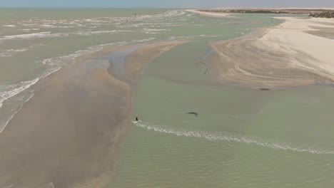 Kitesurfer-cruising-and-jumping-behind-a-sandbank-near-Guriu