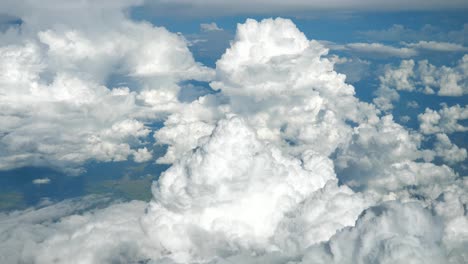 View-from-airplane-window-with-beautiful-clouds-and-land