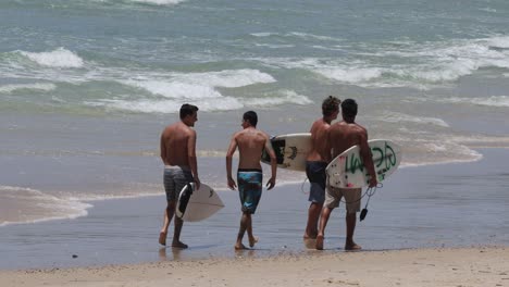 group of surfers walking towards the ocean