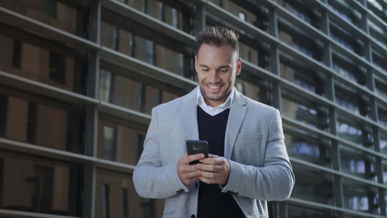 Free stock video - Businessman reading good news on smartphone