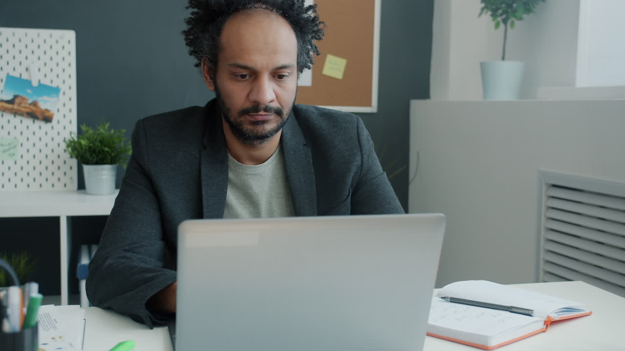 Stressed Businessman Working on Laptop