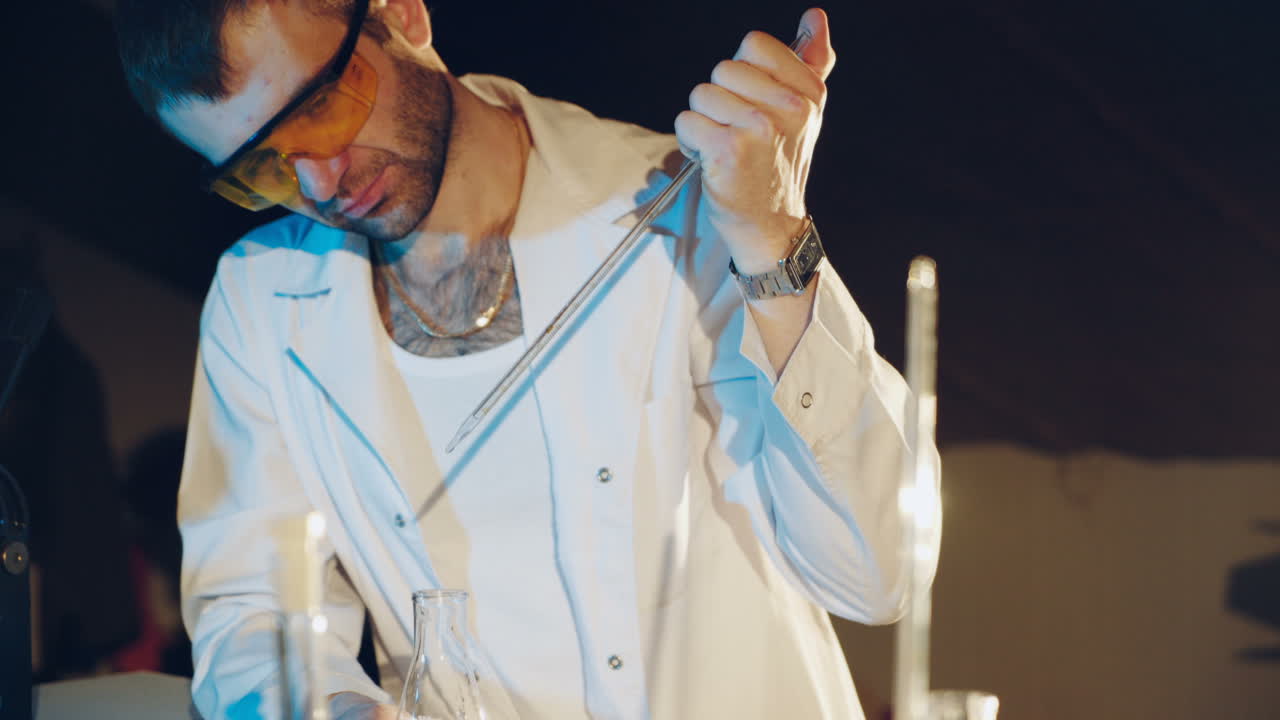 Lab technician scientist performs medical clinic chemical analysis and diagnostics using test tube phial and pipette.