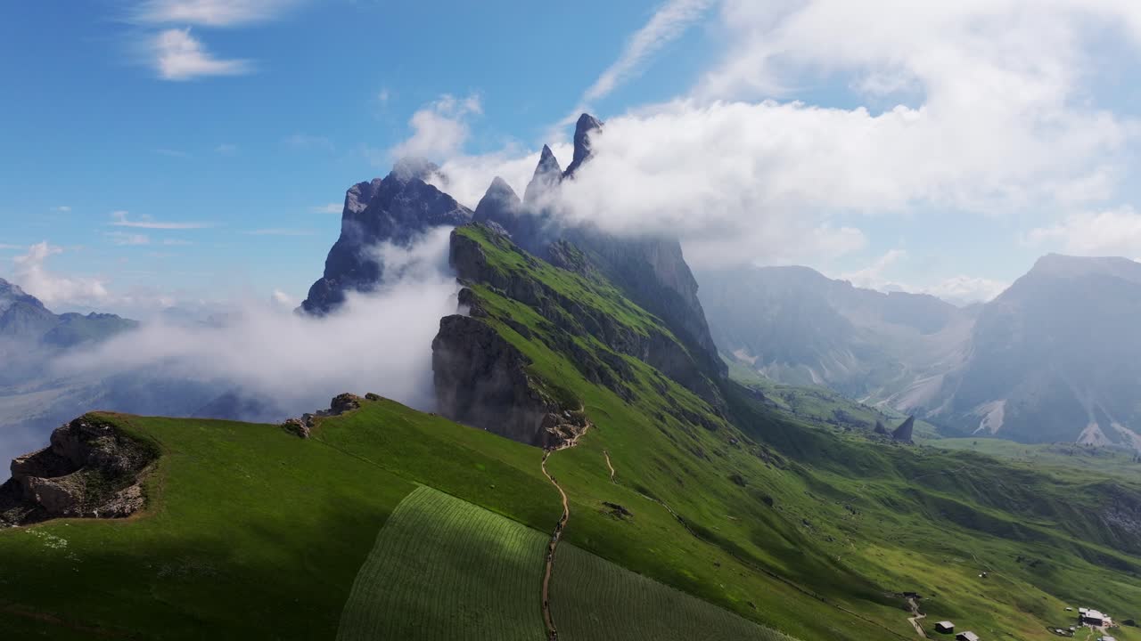 Drone captures Seceda Peak amidst Dolomites' clouds - a true paradise for hikers