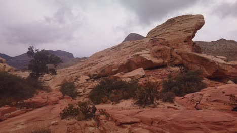 Gimbal-panning-shot-across-the-rugged-terrain-while-scrambling-in-Red-Rock-Canyon,-Nevada