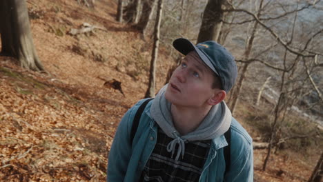 young man walking around and looking up thoughtfully