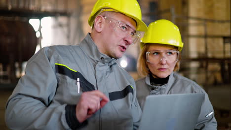 two co-workers talking at work