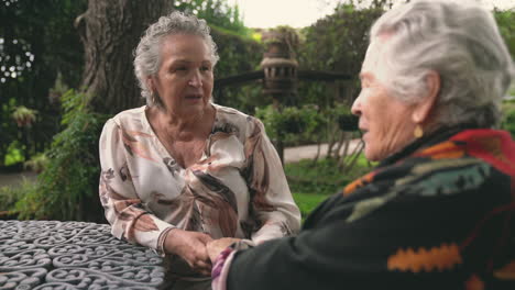 elderly women talking in garden