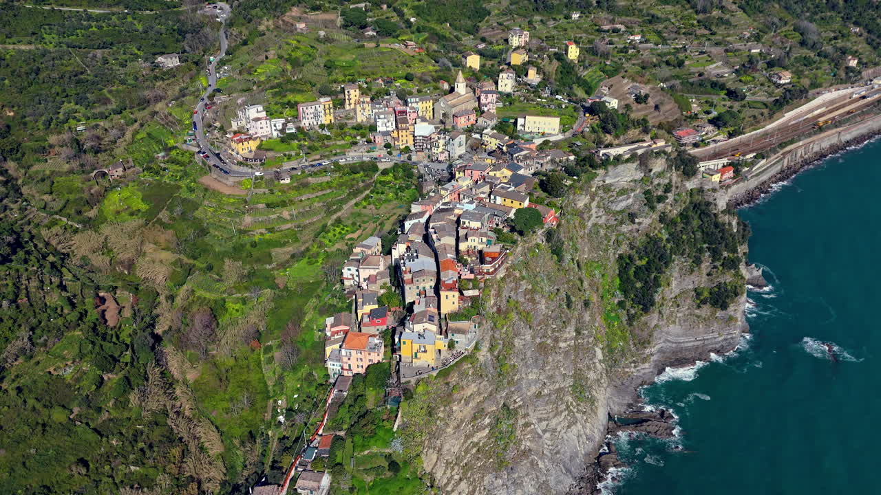 Corniglia, cinque terre, showing colorful houses along a cliff by the sea, aerial view
