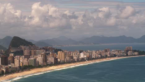 Rio-de-Janeiro,-Brazil-and-the-coast-the-pan-to-reveal-the-slums-of-the-favela-on-the-mountainside---concept:-disparity-of-wealth-verses-poverty