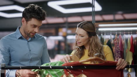 couple customers shopping clothing store closeup. two people choosing clothes