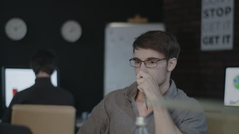 Angry-business-man-throwing-document-paper-on-table-front-laptop-in-late-office