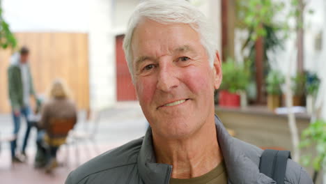 portrait of happy senior man standing in a mall