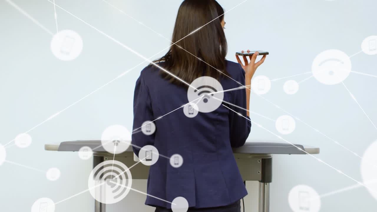 animación de iconos conectados sobre la vista trasera de una mujer biracial de pie y hablando por teléfono celular.