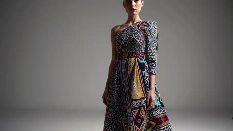 woman in a colorful printed one-shoulder dress