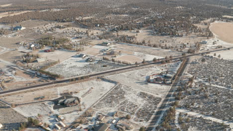 Aerial-shot-over-road-through-rural-Oregon-high-desert-in-winter