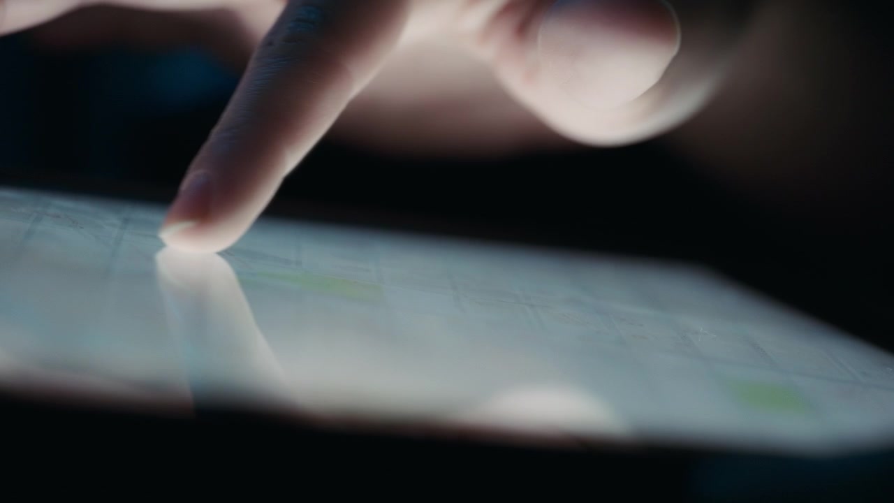 Close up of finger rotating a digital map on a tablet