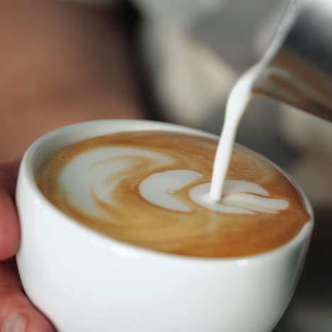 barista making of cafe latte art, heart shape sqare video