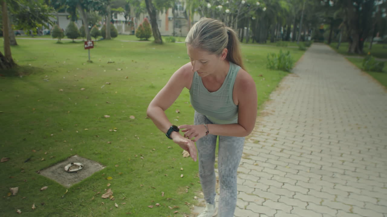 Woman Warming Up before Outdoor Workout in Park