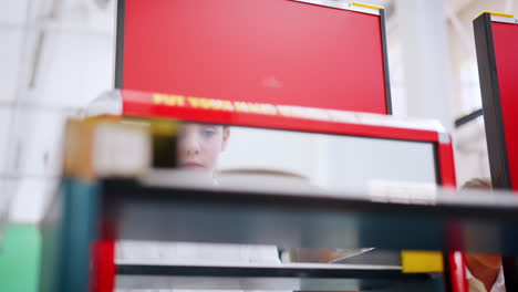 Young-schoolgirl-through-screen-at-a-science-activity-centre