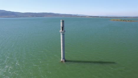 view of mosque minaret at middle of the lake