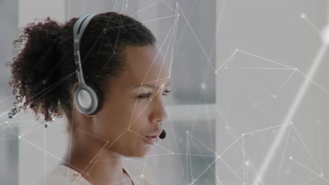 Animation-of-network-of-connections-over-businesswoman-using-phone-headsets