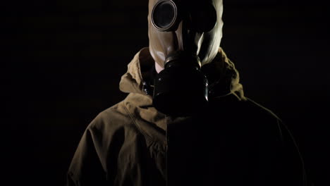 a man in a protective suit and gas mask smoke in the foreground