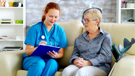 female doctor with red hair taking notes on clipboard