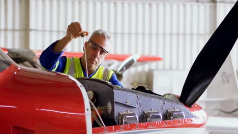 engineer repairing aircraft in hangar 4k