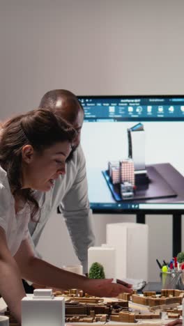 vertical video close up of developers arranging 3d models to explore residential layout