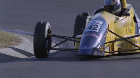 a race car accelerates out of hair pen turn