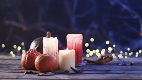 candles and pumpkins set a cozy, festive mood on a wooden surface