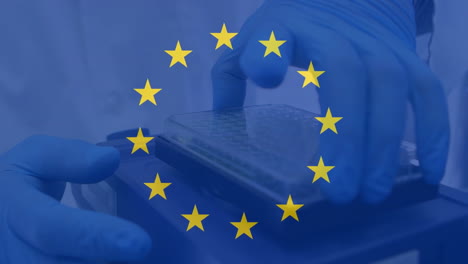 handling scientific equipment, hands in gloves with european union flag animation