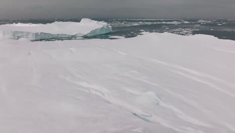 drone over sea and ice of ilulissat icefjord