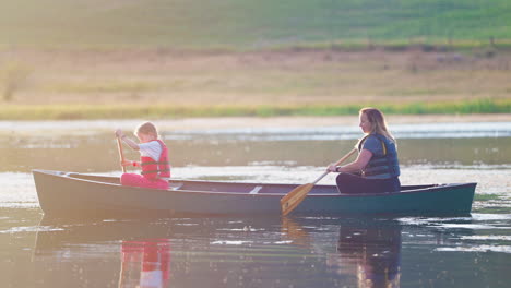 two people canoeing on a calm lake