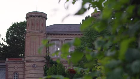 Mansion-in-the-Evening-Light-with-a-Hedge-in-the-Foreground