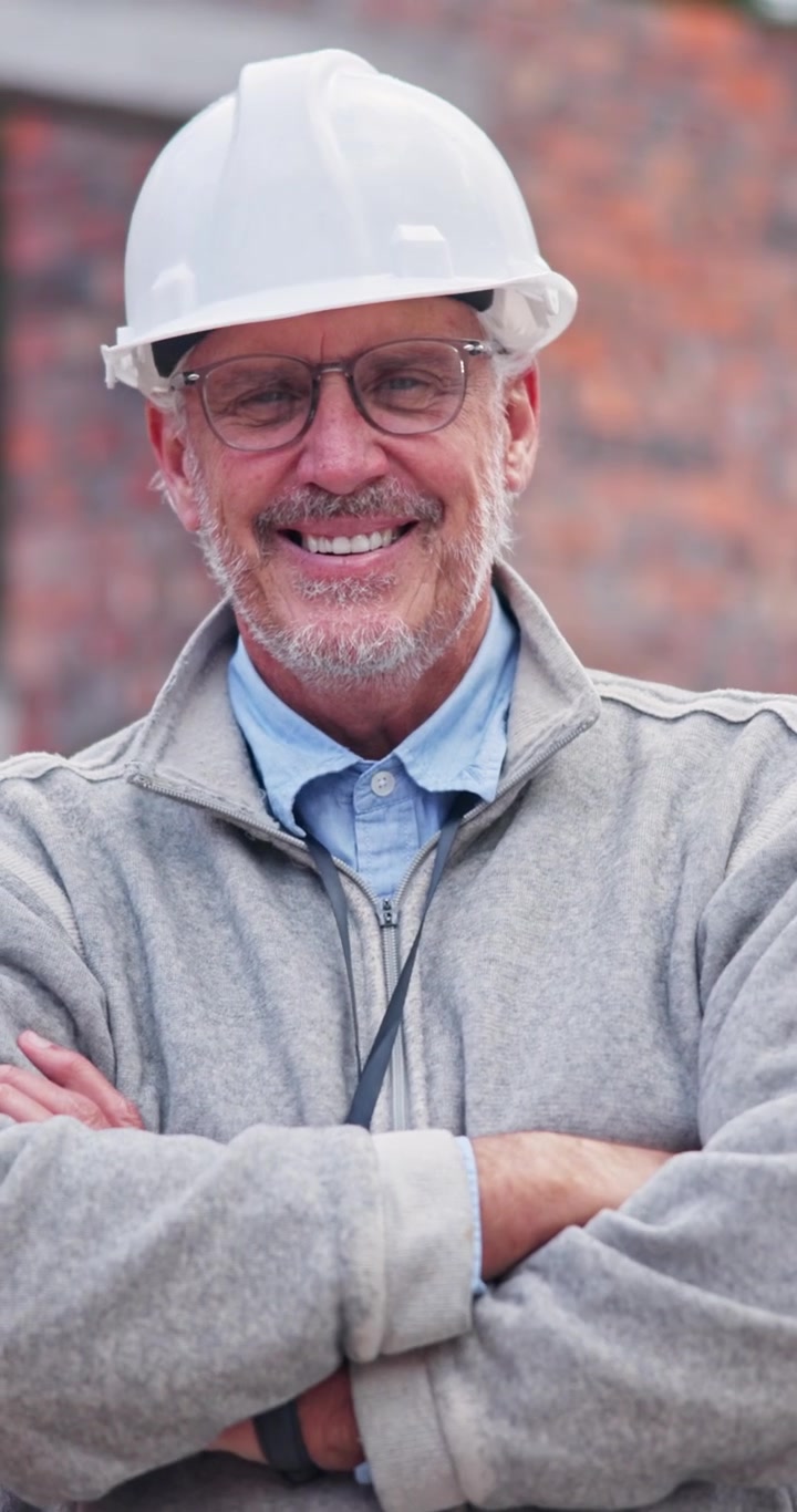 Smiling Mature Construction Manager Wearing Hard Hat