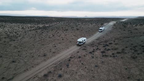 Amidst-the-desolate-terrain-near-Salt-Lake-City,-Utah,-USA,-camper-trucks-roam-freely,-embodying-the-essence-of-van-life:-a-boundless-pursuit-of-freedom,-exploration,-and-adventure