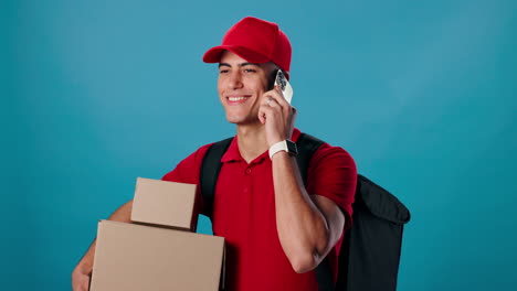 delivery man with packages talking on the phone