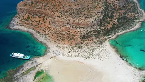 aerial balos twin beach and lagoon with turquoise water, mountains and cliffs in crete, greece