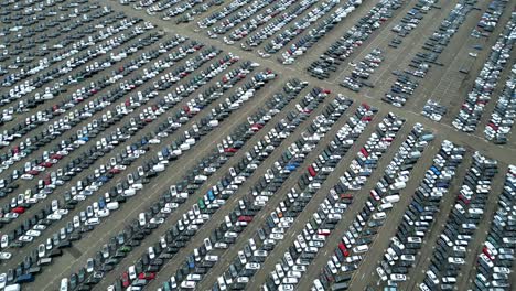 many cars on a parking lot from above, filmed with a drone