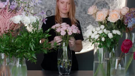 florist arranging flowers in vases