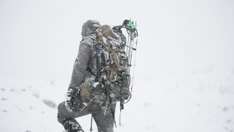 archery bow elk hunting in the snow in montana in october during a snowstorm