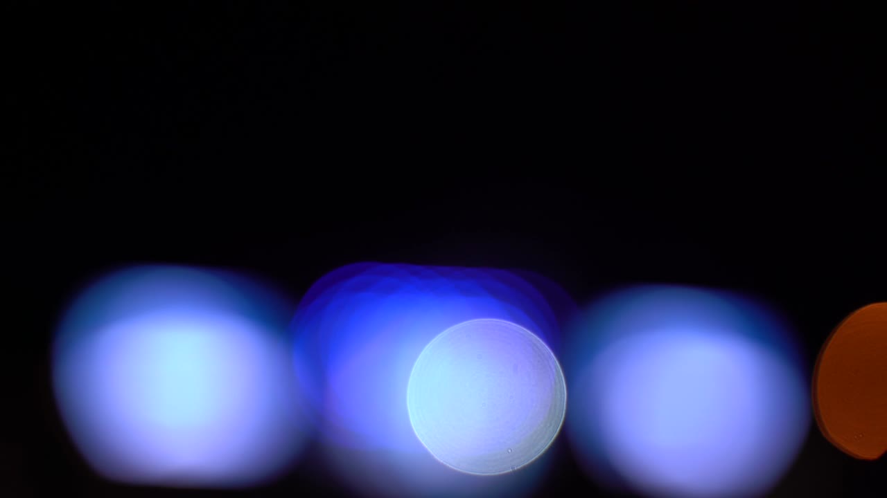 Blurred bokeh traffic on the road at night in a big city,