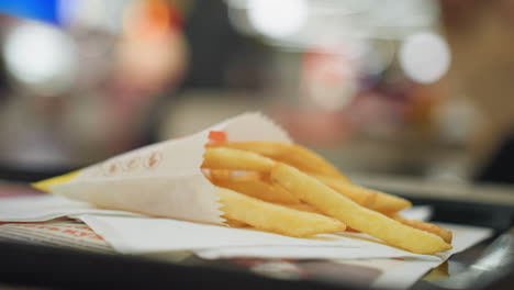 primer plano de patatas fritas doradas en una mesa con un fondo borroso, destacando la textura crujiente y la deliciosa apariencia de las patatas