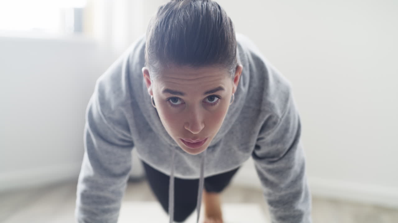 집 에서 플랭크 요가 자세 를 하는 여자