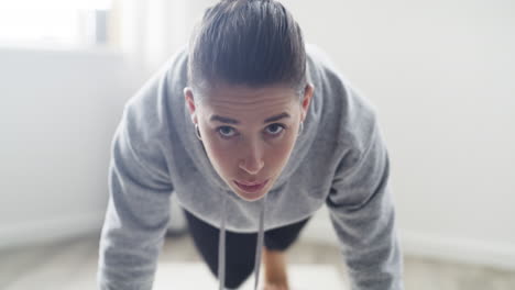 woman performing plank yoga pose at home