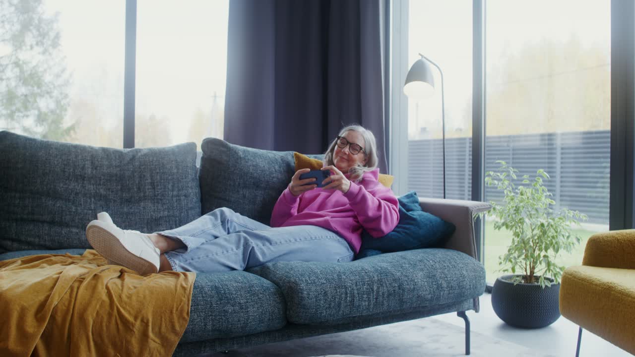 A woman relaxing on the couch at home